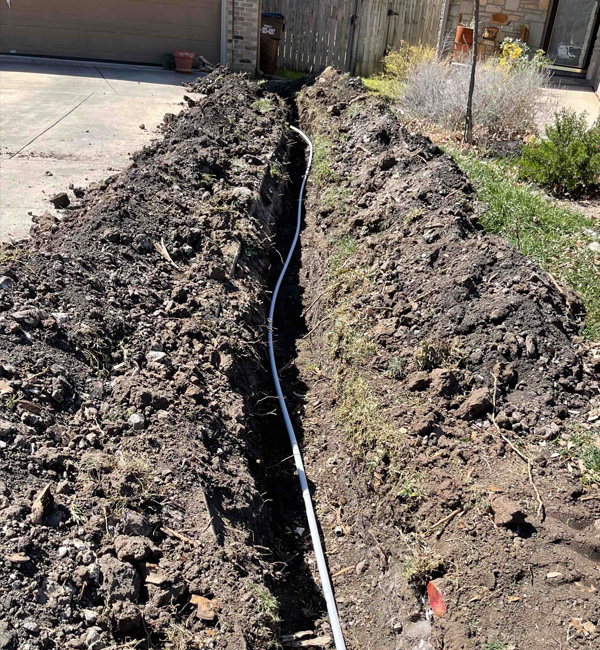 1 inch PVC pipe laid in a trench around a residential property