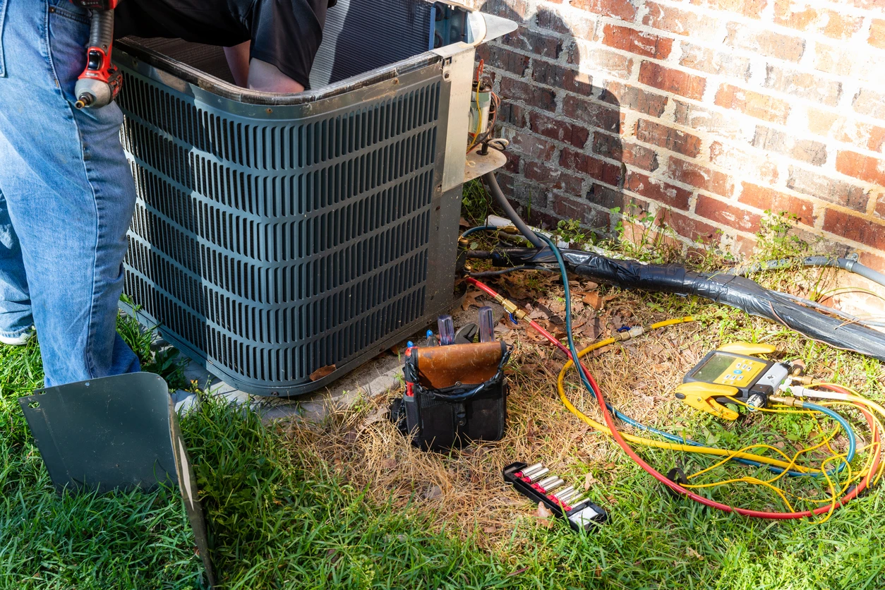 A technician fixing an air conditioner