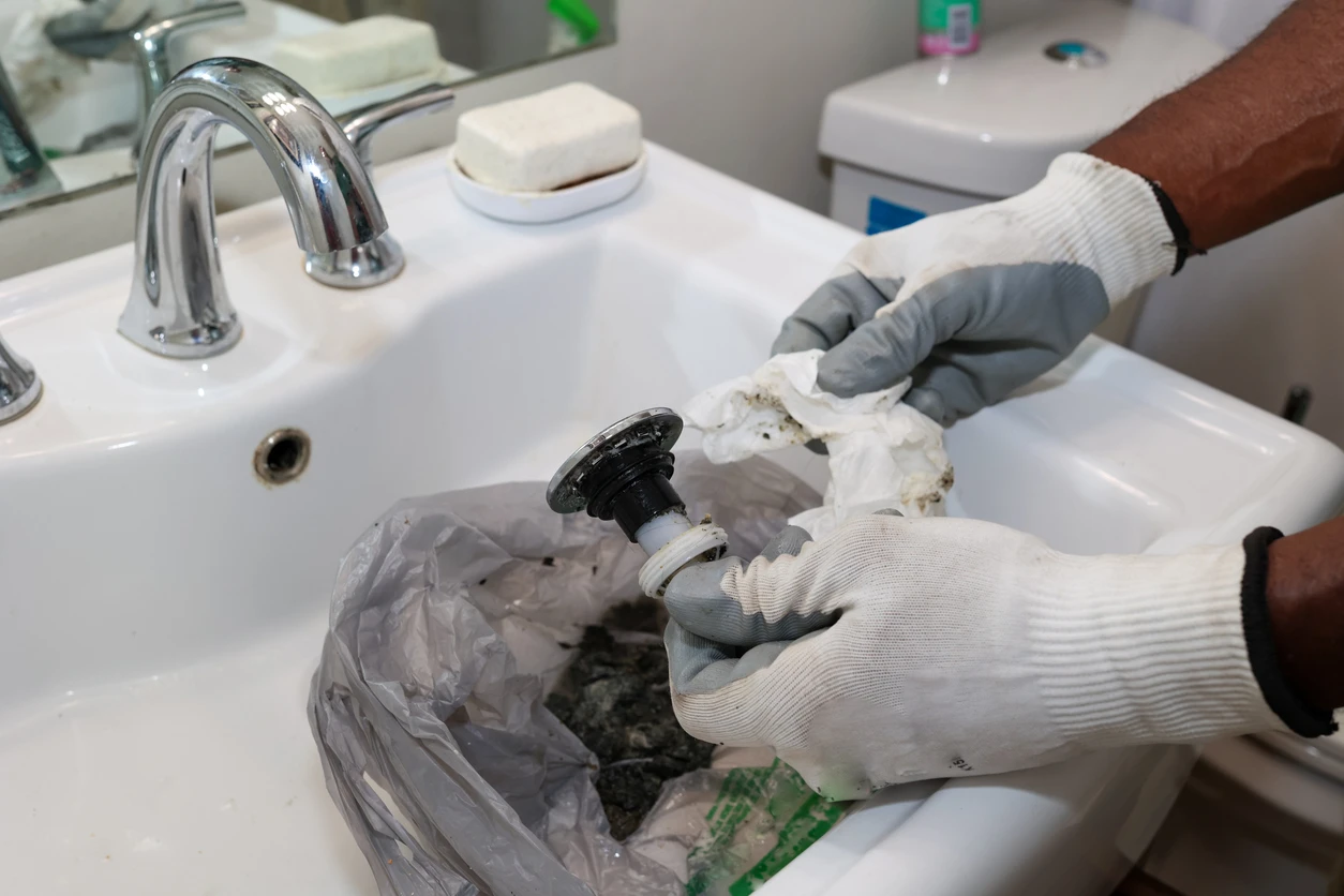 A person is diligently cleaning a sink