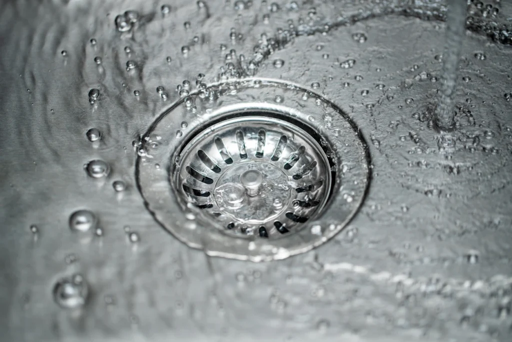 A sink with water running down the drain