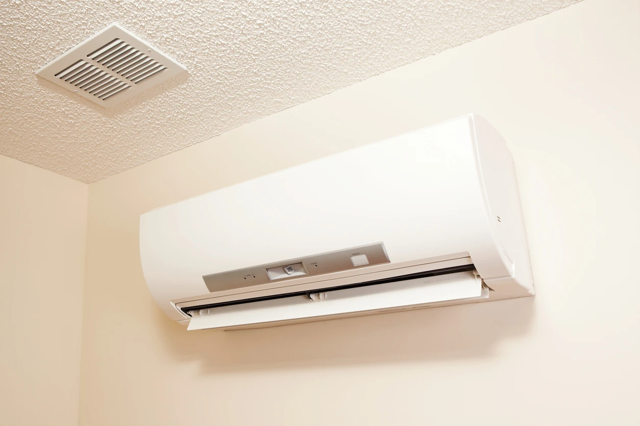 Wall-mounted white air conditioner providing cool air