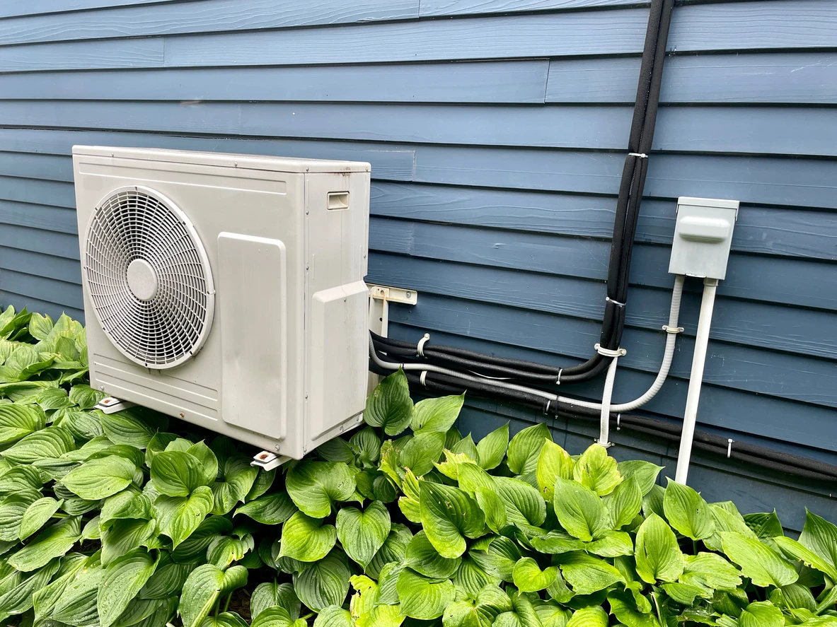 A mini split unit installed outside a residential home