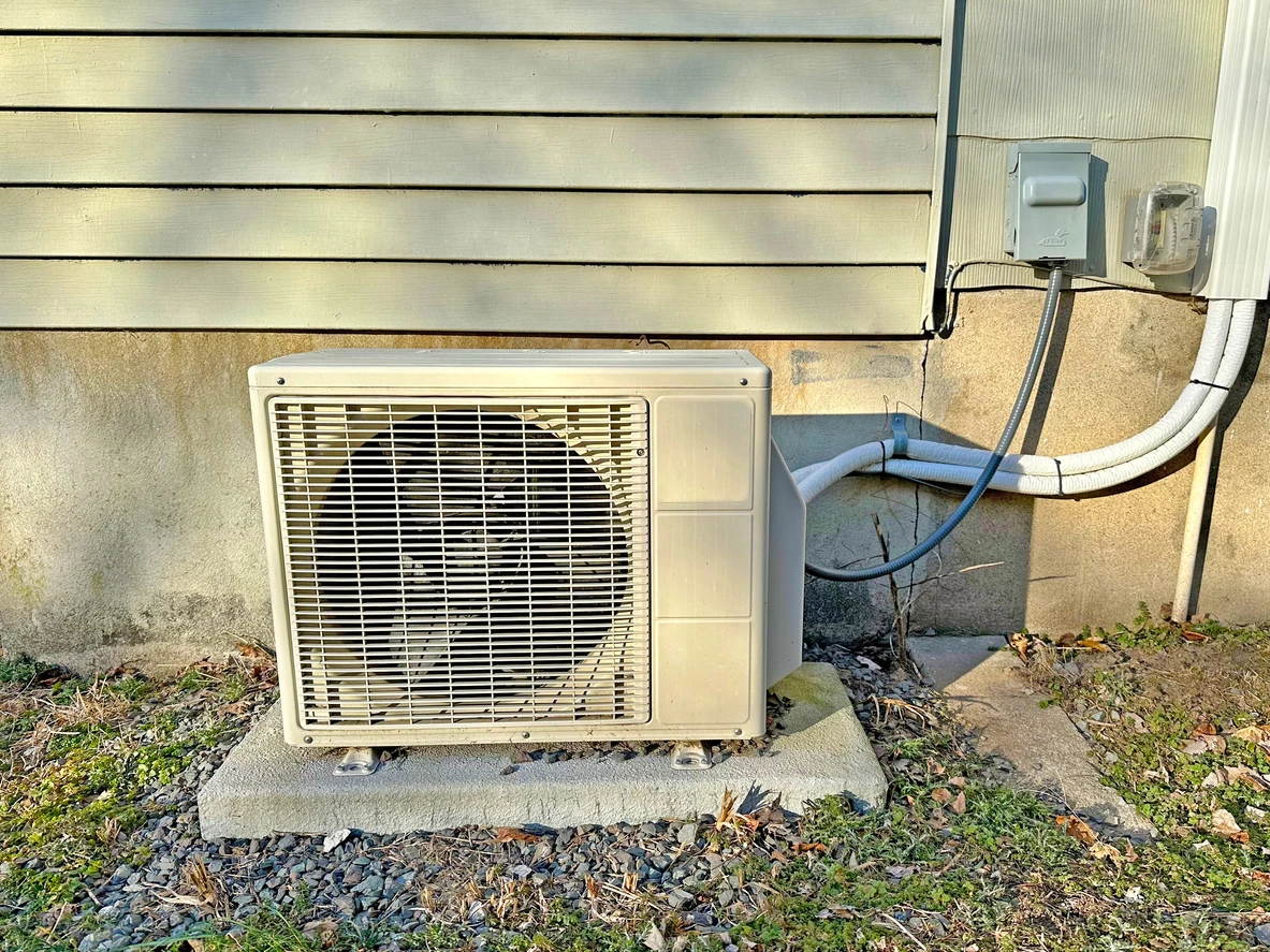 A mini split unit installed outside a residential home