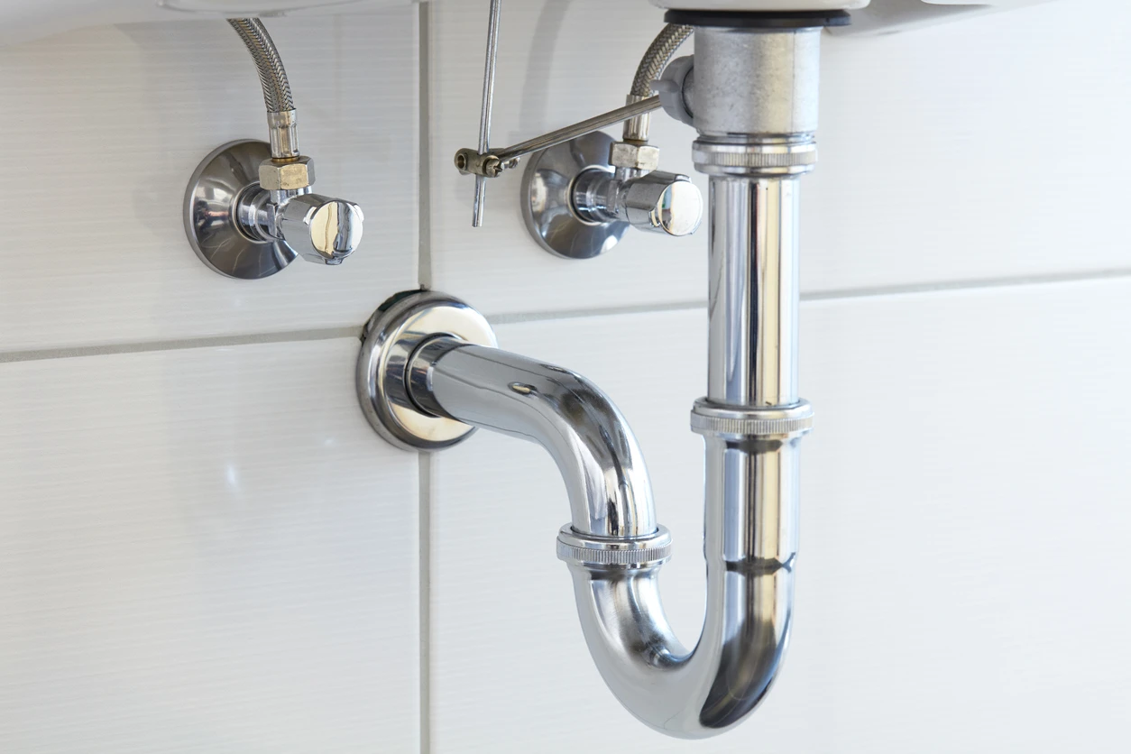 A clean sink featuring a modern faucet and a drain