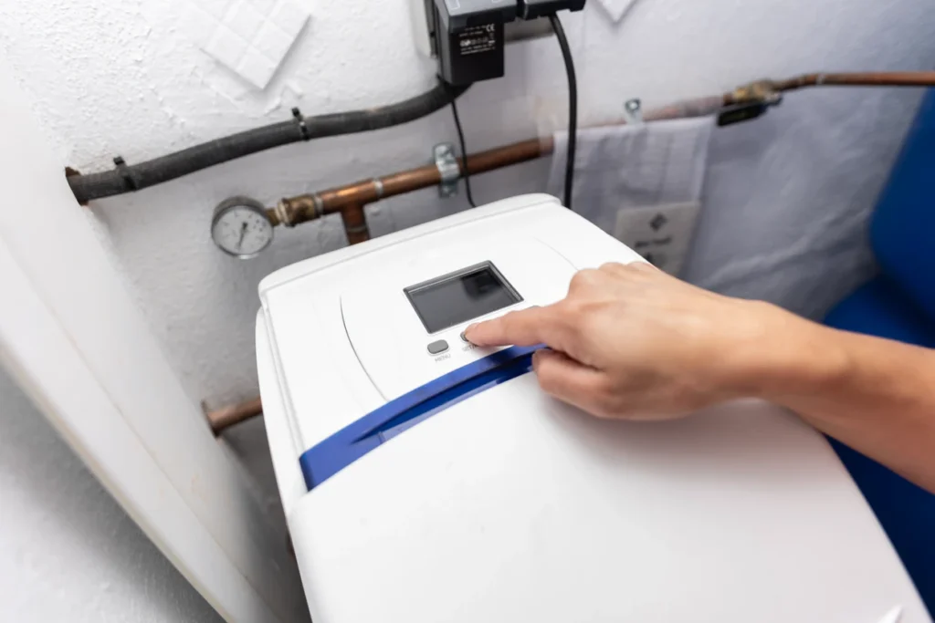 A technician inspecting a water heater