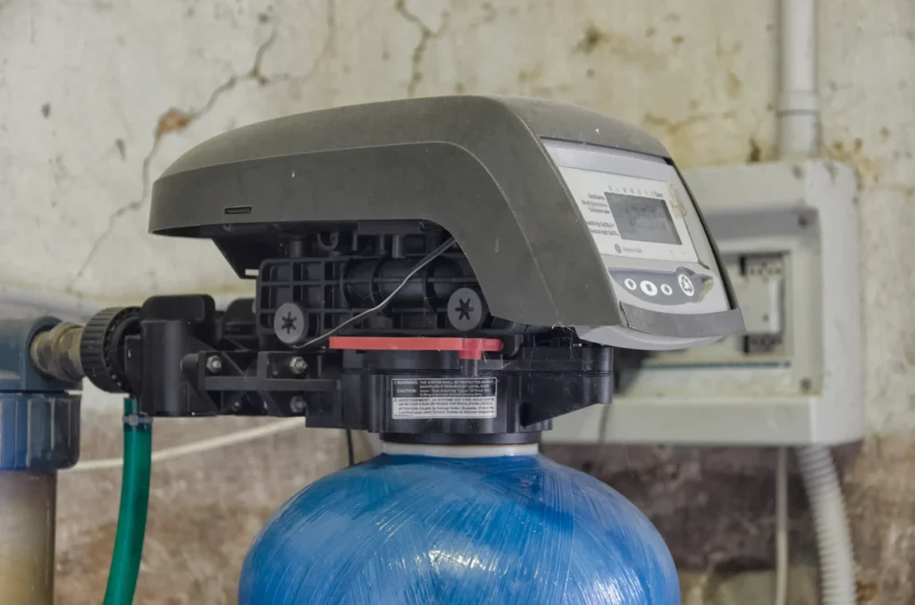 A water softener system connected to a water tank